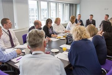 How can civil servants overcome the barriers to working with colleagues from other departments?