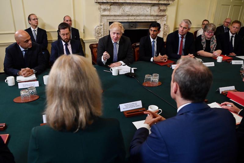 Ministers sit round a table at a cabinet meeting led by Boris Johnson