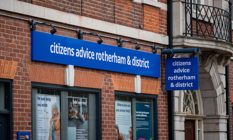 A commercial unit in a brick building with a blue sign and white lettering that reads "citizens advice rotherham & district" 